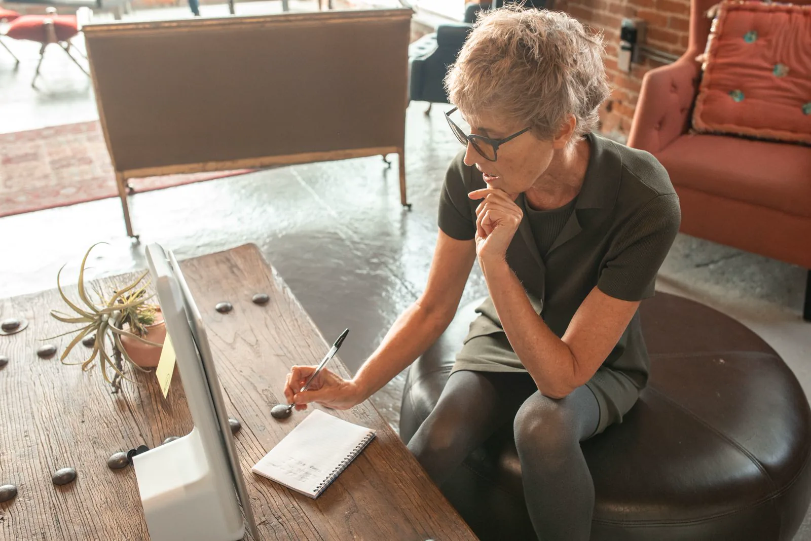 Adult engaged in a written cognitive task in a calm home setting